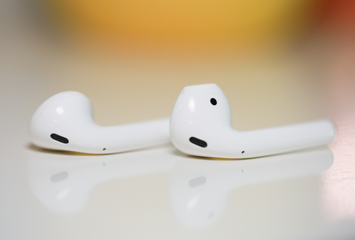Airpods laying on a flat surface. 